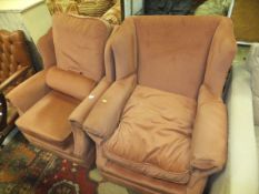 Two modern wing back armchairs with salmon pink upholstery,