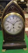 A 19th Century mahogany and brass inlaid mantel clock of lancet form, the movement with circular