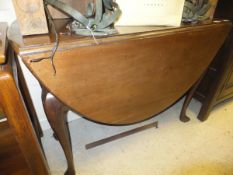 A late George III mahogany oval drop leaf dining table on cabriole legs to shaped padded feet,