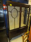 A mahogany astragal glazed three shelf display cabinet with two doors with blind fretwork carving