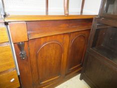 A mahogany chiffonier with single drawer above two cupboard doors on a plinth base