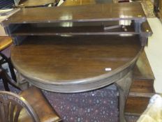 An Edwardian mahogany extending "D end" dining table raised on heavy claw and ball feet