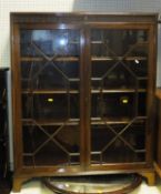 A mahogany bookcase case with two glazed doors opening to reveal shelves