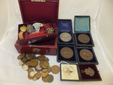 A box containing assorted medals and medallions to include a "Woolwich and Sandhurst Athletics
