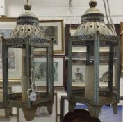 Two large metal lantern candle holders with verdigris finish