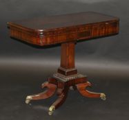 A Victorian mahogany fold-over card table on single square section tapering column, to quatrefoil