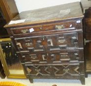A 17th Century and later oak chest of four long drawers on stile supports