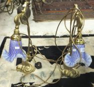 A pair of modern brass Art Nouveau style table lamps with handkerchief glass shades