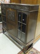 An oak secretaire display cabinet with two glazed doors,