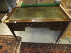 A mahogany writing desk with green leather inset top and five drawers,