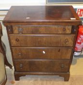 A modern walnut bachelor chest, the fold over top above four long drawers,