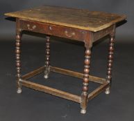 A circa 1700 oak side table, the two plank top with moulded edge above a single frieze drawer on