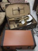 A leather trunk containing various boot trees and a pair of vintage ice skates,