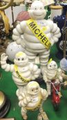 A collection of four painted cast iron Michelin man figures *