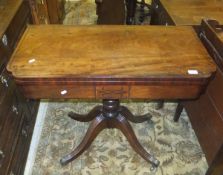 A Regency mahogany and inlaid fold over card table on pedestal quadruped base and castors