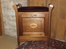 An Edwardian mahogany and inlaid piano stool with fall front music compartment