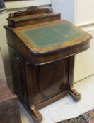 A Victorian walnut Davenport desk with birdseye maple lined interior