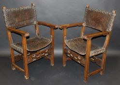 A pair of 17th Century walnut framed Spanish hall chairs with tooled brown leather backs and seat