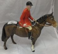 A Beswick pottery figure of a huntsman and horse CONDITION REPORTS Beswick huntsman on horse with