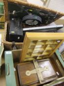 A picnic hamper containing a typewriter, a socket set and vice,