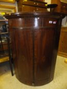 A Georgian mahogany wall mounted corner cupboard,