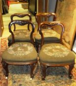 A set of four Victorian bar back nursing chairs raised on brass caps to china casters,