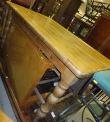 A modern rectangular pine kitchen table on turned legs,