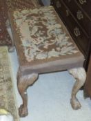 A circa 1900 needlework upholstered dressing stool of shell carved cabriole legs to claw and ball