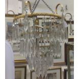 A four tier gilt metal light fitting with cut glass drops,