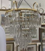 A four tier gilt metal light fitting with cut glass drops,