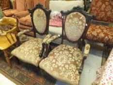 A pair of Victorian mahogany framed salon chairs with serpentine front seat and peach ground