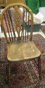 A set of four wheel back kitchen chairs,