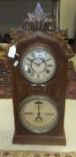 A walnut cased calendar mantel clock by the Ithaca Calendar Clock Co.