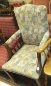 A 19th Century upholstered open arm elbow chair in the Chippendale taste