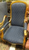 A Victorian beech framed armchair with serpentine shaped front and blue ground upholstery