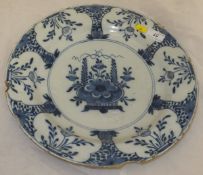 An 18th Century Delft charger, decorated with floral designs in the Chinese manner,