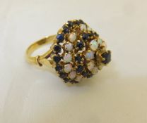 A modern 18 carat gold opal and blue stone set dress ring