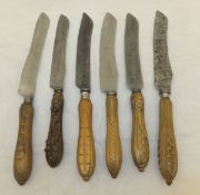 A collection of twelve early 20th Century wooden handled bread knives,