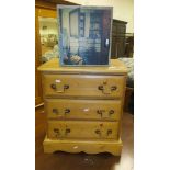 A pine bedside chest of three drawers,