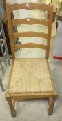 A beech framed ladder back rush seated chair,