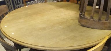 A pine circular topped kitchen table on pedestal base