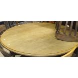 A pine circular topped kitchen table on pedestal base