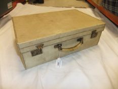 A velum covered suitcase marked "MER", stamped "Finnigan's Makers Bond St London", 50.5 x 16.