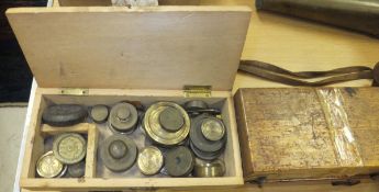 Two wooden cases containing various brass weights,