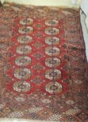 A Bokhara rug, the two central rows of elephant foot medallions in cream, red,