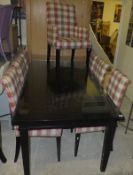 A modern ebony rectangular dining table on square tapered legs,