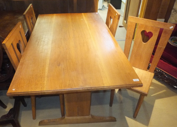 An oak refectory table and four chairs with pierced loveheart decoration to the back splats