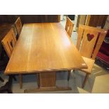 An oak refectory table and four chairs with pierced loveheart decoration to the back splats