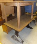 An oak refectory style dining table on square supports united by central stretcher,