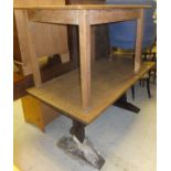An oak refectory style dining table on square supports united by central stretcher,